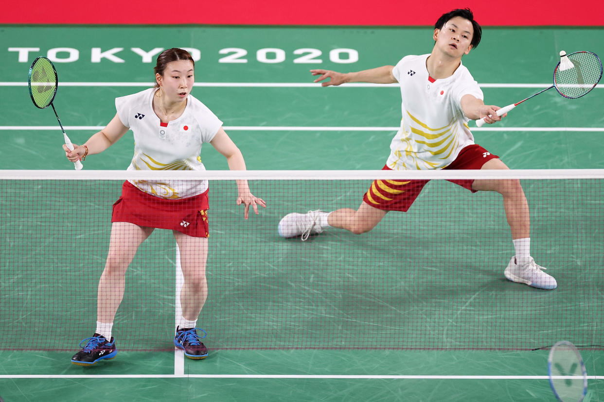 CHOFU, JAPAN - JULY 26: Yuta Watanabe(right) and Arisa Higashino of Team Japan compete against Praveen Jordan and Melati Daeva Oktavianti of Team Indonesia during a Mixed Doubles Group C match on day three of the Tokyo 2020 Olympic Games at Musashino Forest Sport Plaza on July 26, 2021 in Chofu, Tokyo, Japan. (Photo by Lintao Zhang/Getty Images)