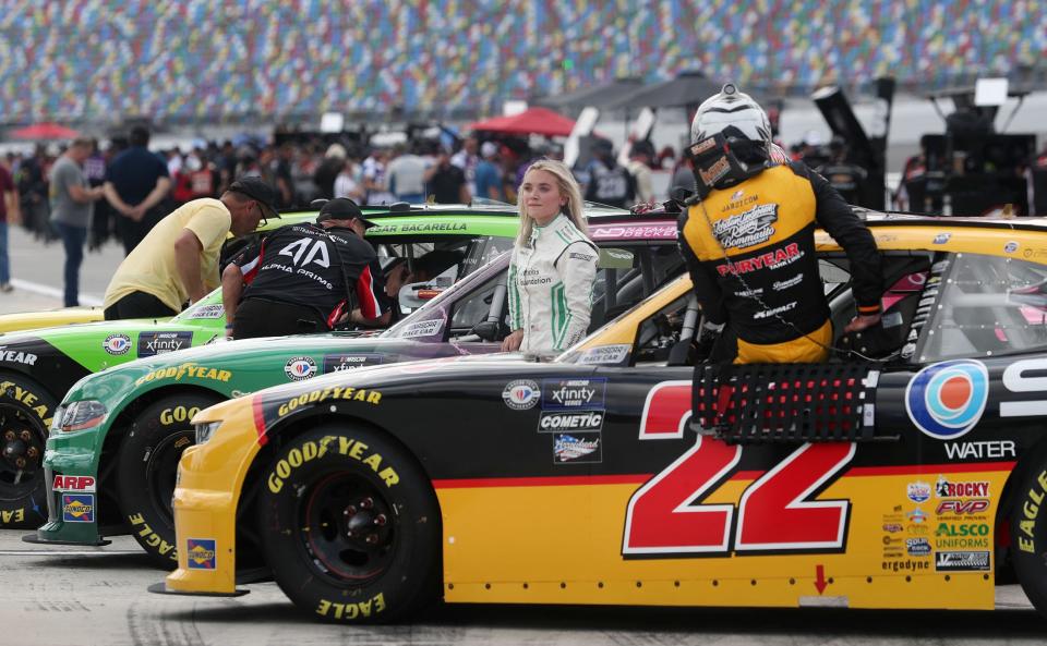 Natalie Decker stands next to her no. 53 Ford as Jeb Burton climbs out of his no. 22 Chevrolet on pit road, Friday August 25, 2023 during qualifying for the Xfinity Wawa 250 at Daytopna International Speedway.