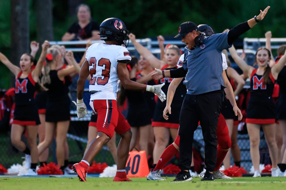 Middleburg head coach Ryan Wolfe, right, celebrates a defensive stop. The Broncos rallied from 26 points down to defeat Clay.
