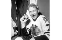 FILE - Bobby Hull of the Chicago Blackhawks holds puck which he drove into New York Rangers' net to score his 50th goal of the season in New York's Madison Garden on March 25, 1962. Hull, a Hall of Fame forward who helped the Blackhawks win the 1961 Stanley Cup Final, has died. He was 84. The Blackhawks and the NHL Alumni Association announced the death of the two-time NHL MVP on Monday, Jan. 30, 2023. (AP Photo/Marty Lederhandler, file)