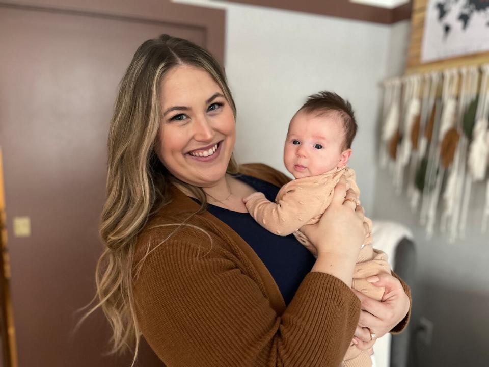 Mom Ashley Thomassen is pictured with her daughter, who is now three months old. Thomassen checked into a 'postnatal retreat' in Toronto for two weeks after giving birth. (Laura MacNaughton/CBC - image credit)
