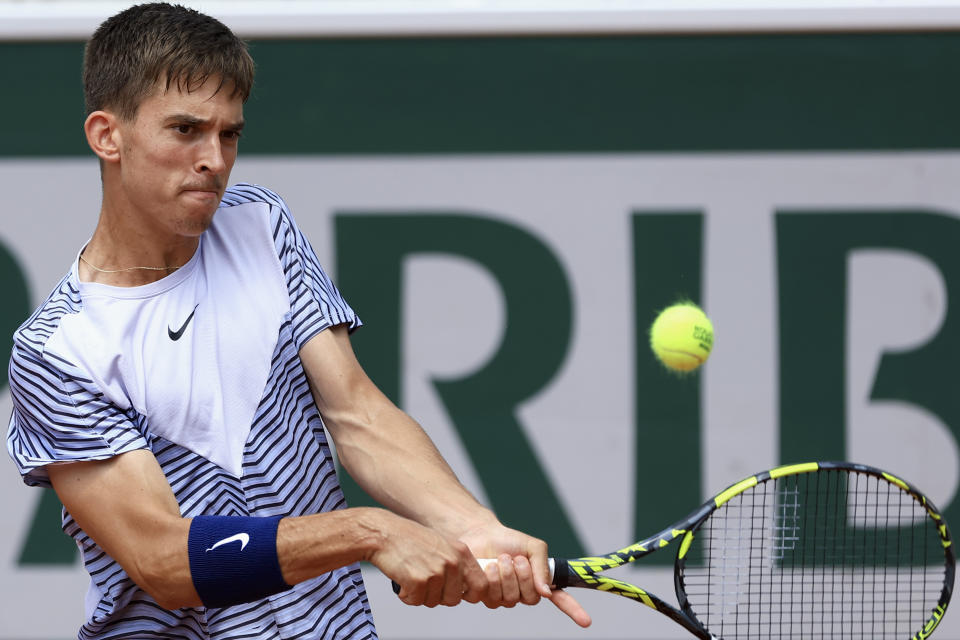 Croatia's Dino Prizmic plays a shot against Bolivia's Juan Carlos Prado Angelo during their final match of the Boys' Singles French Open tennis tournament at the Roland Garros stadium in Paris, Saturday, June 10, 2023. (AP Photo/Aurelien Morissard)