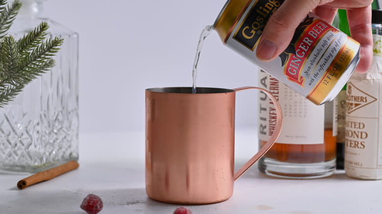 pouring ginger beer into mug