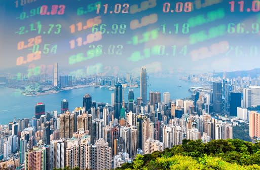 Hong Kong skyline during the day with financial numbers at top