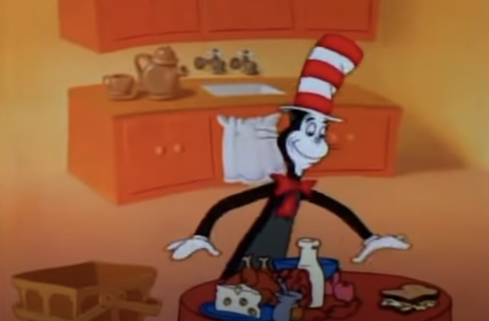 The cat in the hat preparing a bunch of food in his kitchen