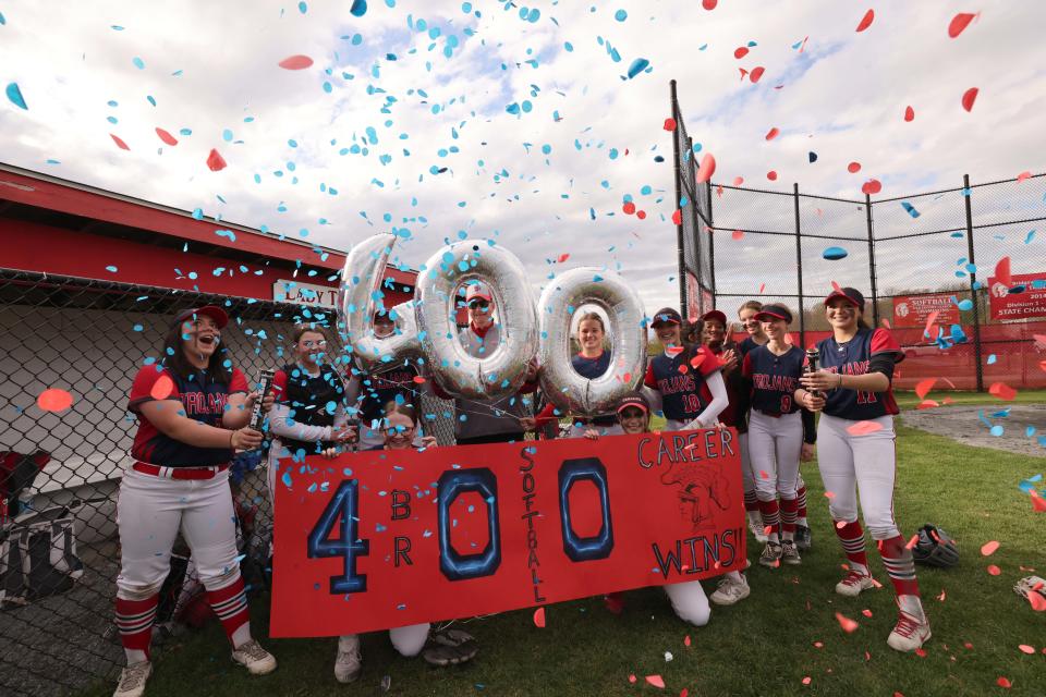Bridgewater-Raynham head coach Mike Carrozza celebrates with players after he won his 400th career game versus Brockton on Wednesday, May 3, 2023. 
