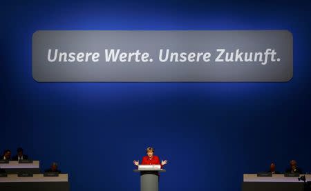 German Chancellor and leader of the conservative Christian Democratic Union party CDU Angela Merkel addresses the CDU party convention in Essen, Germany, December 6, 2016. REUTERS/Wolfgang Rattay