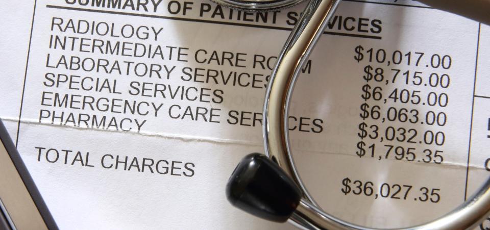 Medical bill summary with various charges listed alongside a calculator and stethoscope