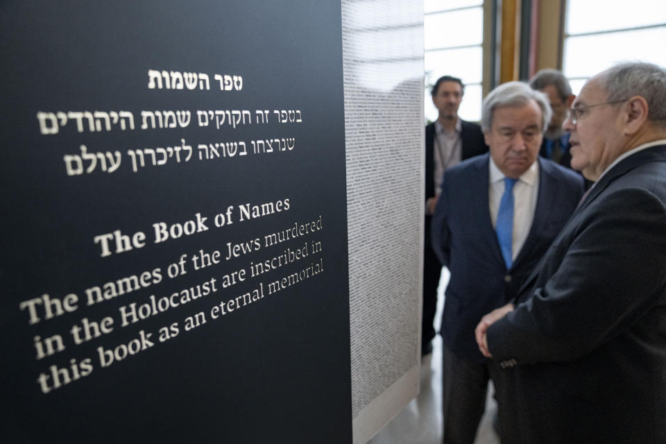 Antonio Guterres, United Nations Secretary General, center, and Dani Dayan, Chairman of Yad Vashem, far right, browse the Yad Vashem Book of Names of Holocaust Victims Exhibit, Thursday, Jan. 26, 2023, at United Nations headquarters. (AP Photo/John Minchillo)