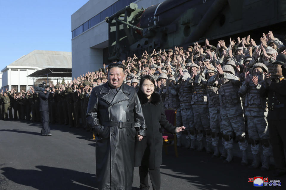 This undated photo provided on Nov. 27, 2022, by the North Korean government shows North Korean leader Kim Jong Un, center, and his daughter, center right, posing with soldiers who were involved in the the recent launch of what it says a Hwasong-17 intercontinental ballistic missile, at an unidentified location in North Korea. Independent journalists were not given access to cover the event depicted in this image distributed by the North Korean government. The content of this image is as provided and cannot be independently verified. Korean language watermark on image as provided by source reads: "KCNA" which is the abbreviation for Korean Central News Agency. (Korean Central News Agency/Korea News Service via AP)