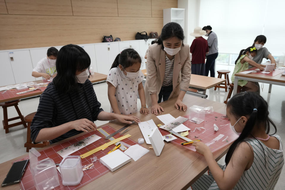 Song Hyo Eun, left, a 39-year-old South Korean, attends a handicraft class at the Inter-Korean Cultural Integration Center in Seoul, South Korea, on June 10, 2021. The center, which opened last year, is South Korea’s first government-run facility to bring together North Korean defectors and local residents to get to know each other through cultural activities and fun. It’s meant to support defectors’ often difficult resettlement in the South, but also aims at studying the possible blending of the rivals’ cultures should they unify. (AP Photo/Ahn Young-joon)