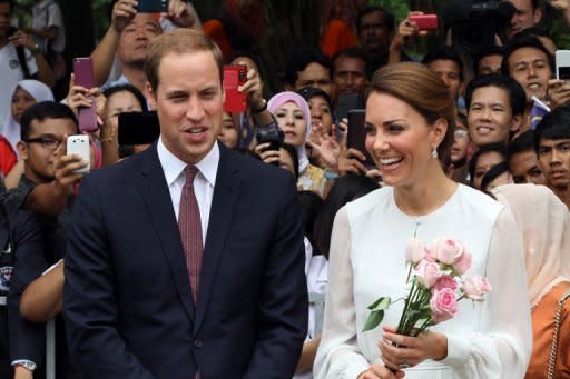 Britain's Prince William and his wife Catherine, the Duchess of Cambridge, walk in the gardens of the KLCC in Kuala Lumpur on September 14. A French magazine has said it will publish topless pictures of Kate on Friday, in a move met with dismay by the royal couple