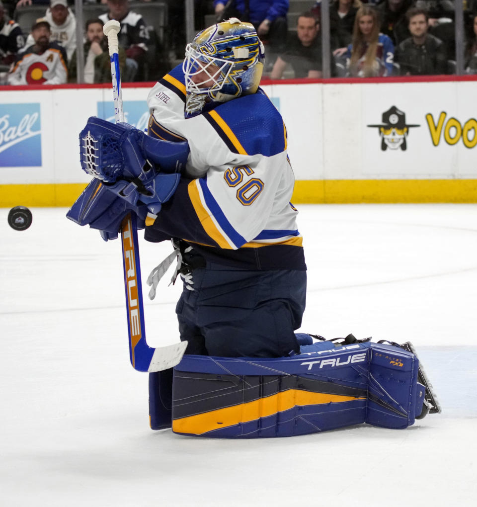 St. Louis Blues goaltender Jordan Binnington makes a stop in the third period of an NHL hockey game against the Colorado Avalanche, Saturday, Jan. 28, 2023, in Denver. (AP Photo/David Zalubowski)