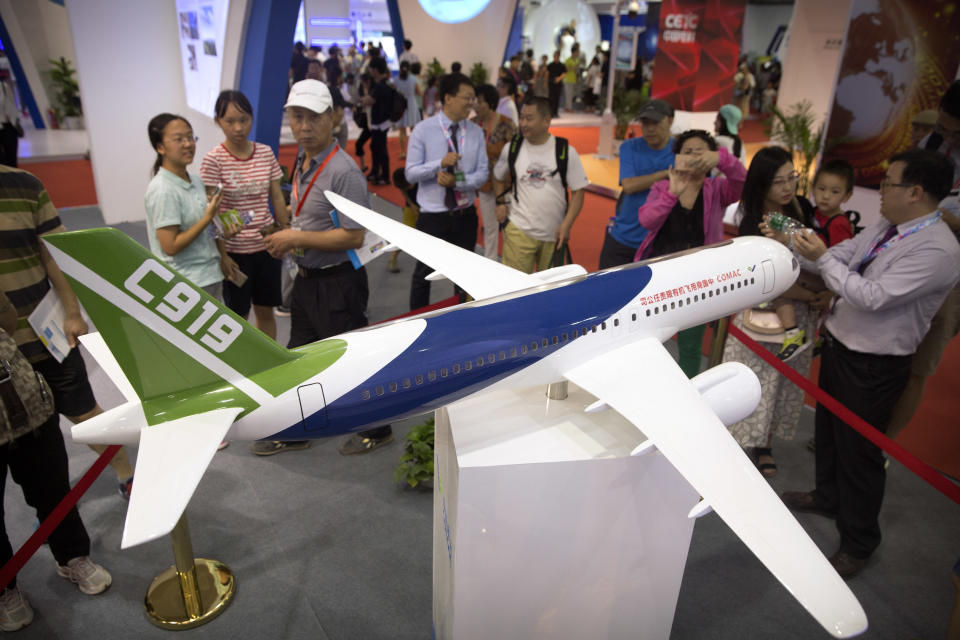 Visitors look at a model of China’s domestically made C919 passenger jet at the China Beijing International High-Tech Expo in Beijing, Saturday, June 10, 2017. The annual forum and exhibition is a showcase for Chinese domestic technology companies and innovation. (AP Photo/Mark Schiefelbein)