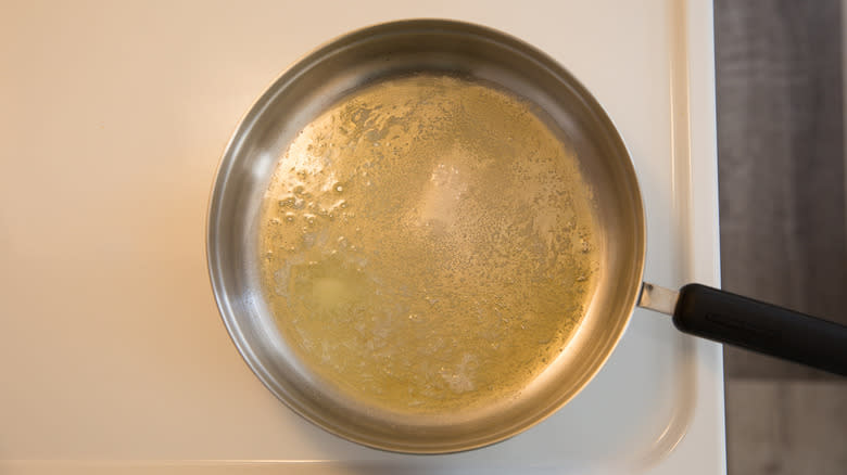 butter melting on stovetop skillet 