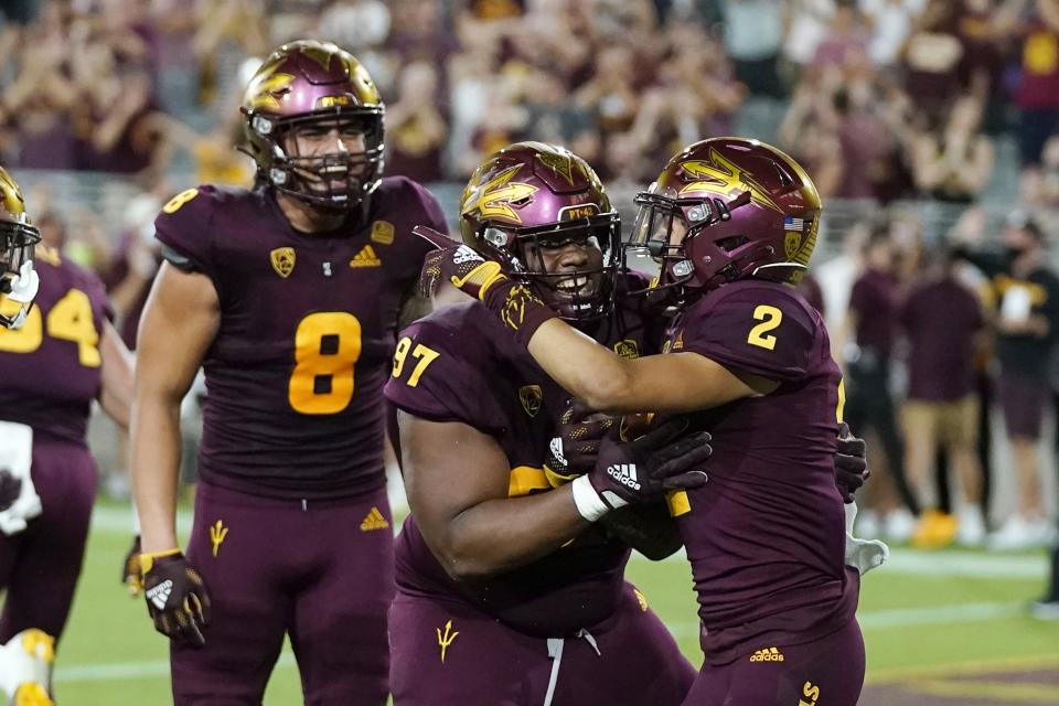 Arizona State defensive back DeAndre Pierce (2) celebrates his touchdown against Stanford with defensive lineman Shannon Forman (97) and linebacker Merlin Robertson (8) during the second half of an NCAA college football game Friday, Oct. 8, 2021, in Tempe, Ariz. (AP Photo/Ross D. Franklin)