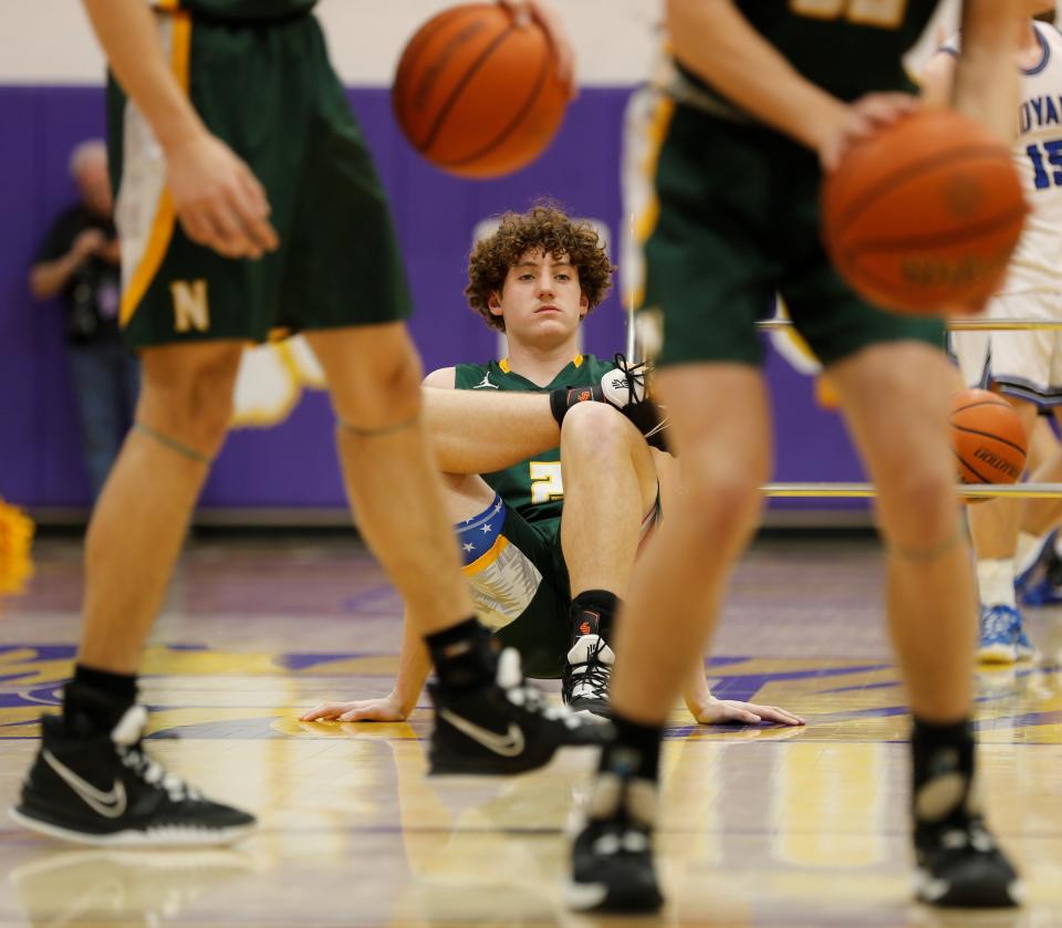 Northeastern junior Carson Terrell stretches during warmups before the sectional championship game against Eastern Hancock at Hagerstown High School.