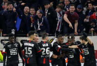 Soccer Football - Ligue 1 - Olympique Lyonnais vs Rennes - Groupama Stadium, Lyon, France - February 11, 2018 Stade Rennes’ Wahbi Khazri (hidden) celebrates scoring their first goal with team mates as Lyon fans gesture REUTERS/Emmanuel Foudrot