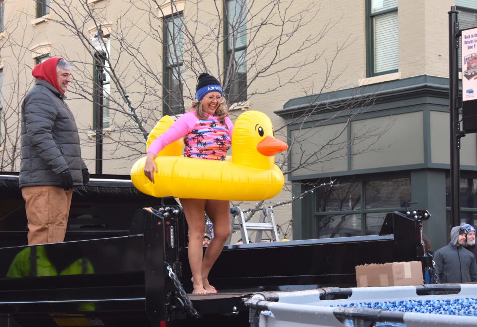 Adrian Mayor Angie Sword Heath prepares to take the plunge into an icy, cold pool of water Friday, Feb. 3, 2023, during the Maple Frost Plunge in downtown Adrian as part of First Fridays for February. Assisting the participants in the fundraising plunge event was Adrian Main Street Executive Director Jay Marks, left.