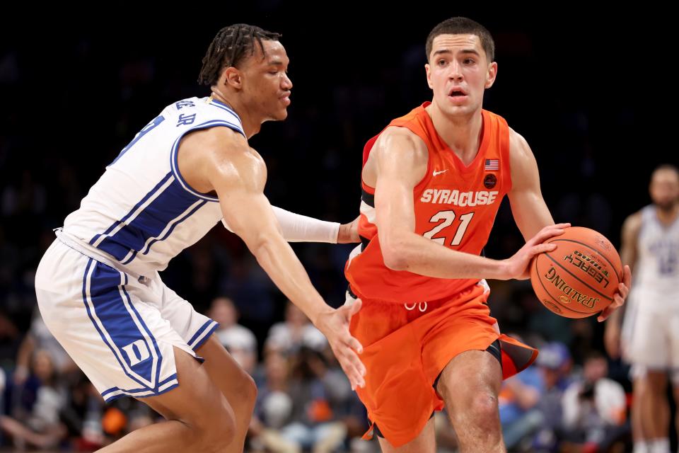 Syracuse forward Cole Swider looks to pass around Duke forward Wendell Moore Jr. during an ACC conference tournament game in March at Barclays Center in Brooklyn.