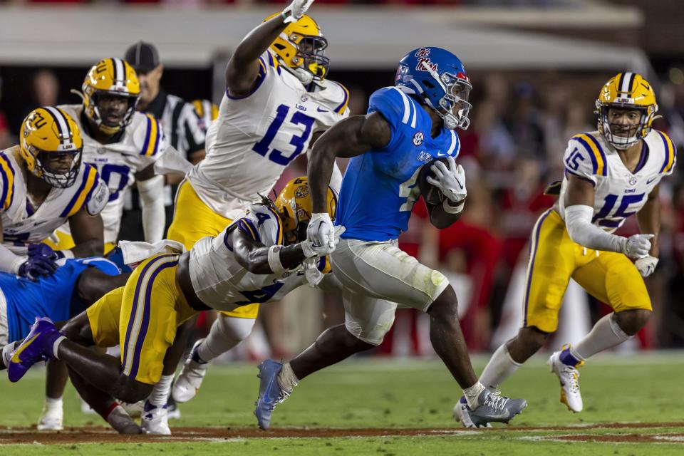 Mississippi running back Quinshon Judkins (4) runs with LSU linebacker Harold Perkins Jr. (4) trailing during the second half of an NCAA football game on Saturday, Sept. 30, 2023, in Oxford, Miss. | Vasha Hunt, AP