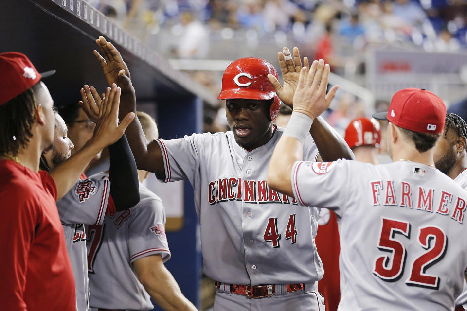 MIAMI, FLORIDA - AUGUST 28:  Aristides Aquino #44 of the Cincinnati Reds celebrates with teammates after scoring a run in the fourth inning against the Miami Marlins at Marlins Park on August 28, 2019 in Miami, Florida. (Photo by Michael Reaves/Getty Images)