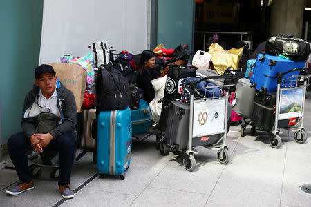 People wait with their luggage at Heathrow Terminal 5 in London, Britain May 27, 2017. REUTERS/Neil Hall