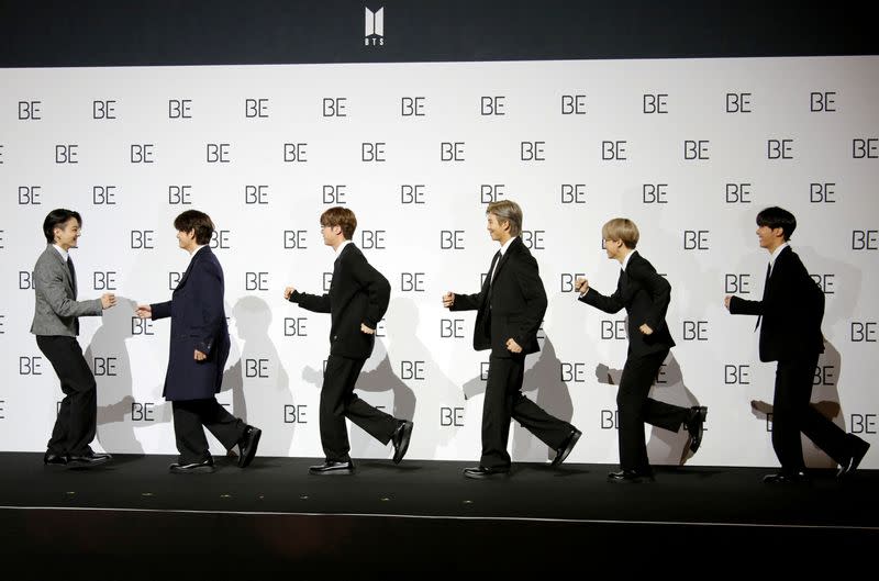 FILE PHOTO: Members of K-pop boy band BTS pose for photographs during a news conference promoting their new album "BE(Deluxe Edition)" in Seoul