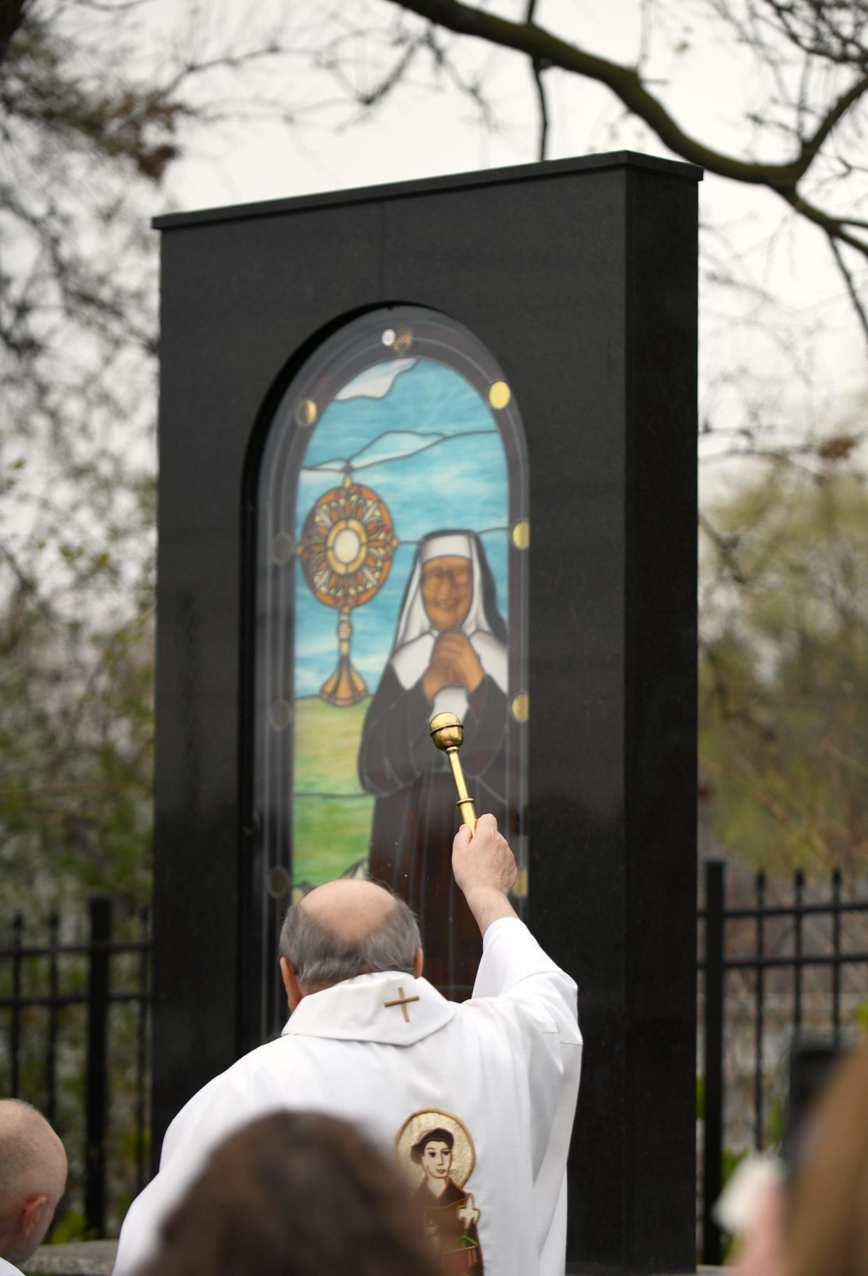 The Rev. Nicholas Mancini celebrates the birthday of Mother Angelica with a Mass and dedication ceremony for a new monument at the St. Raphael Center in Canton.