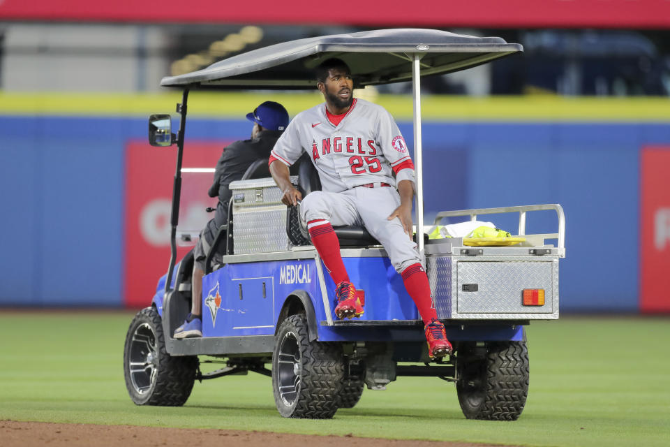 Los Angeles Angels' Dexter Fowler is carted off after a play at second base against the Toronto Blue Jays during the second inning of a baseball game Friday, April 9, 2021, in Dunedin, Fla. (AP Photo/Mike Carlson)