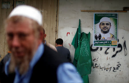 A poster depicting a Palestinian electrical engineer Fadi al-Batash, who was shot to death in Malaysia, hangs on a wall of his family house in the northern Gaza Strip April 21, 2018. REUTERS/Mohammed Salem