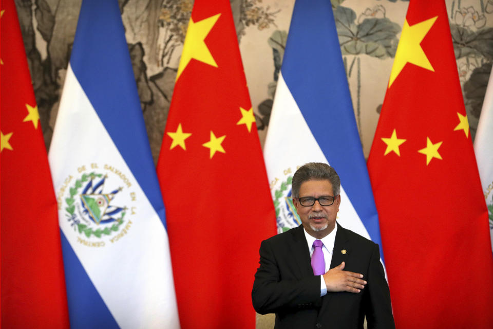 El Salvador's Foreign Minister Carlos Castaneda stands as his country's national anthem is played at a signing ceremony to mark the establishment of diplomatic relations between El Salvador and China at the Diaoyutai State Guesthouse in Beijing, China, Tuesday, Aug. 21, 2018. Taiwan says it is breaking off diplomatic ties with El Salvador because the Central American country plans to defect to rival Beijing. The move is the latest blow to the self-ruled island that China has been trying to isolate on the global stage. (AP Photo/Mark Schiefelbein)