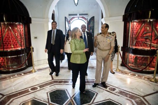 Field Marshal Mohamed Tantawi walks with US Secretary of State Hillary Clinton to a meeting at the Ministry of Defense in Cairo, Egypt. Clinton met Sunday with Egypt's top military leaders, urging them to support a transition to civilian rule as a political struggle triggers fears that rights could be eroded