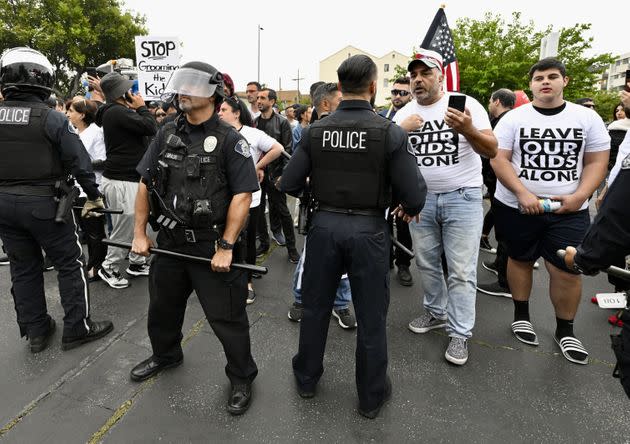 Protesters wear shirts reading 