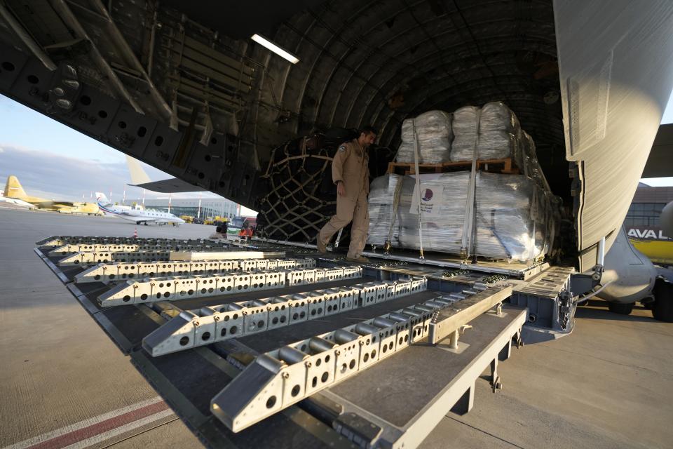 A Qatar Emiri Air Force officer prepares to offload supplies of assistance packages, in Gaziantep, southeastern Turkey, Tuesday, Feb 7, 2023. Search teams and international aid poured into Turkey and Syria on Tuesday as rescuers working in freezing temperatures and sometimes using their bare hands dug through the remains of buildings flattened by a powerful earthquake. (AP Photo/Kamran Jebreili)