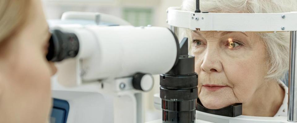 Young female ophthalmologist using apparatus