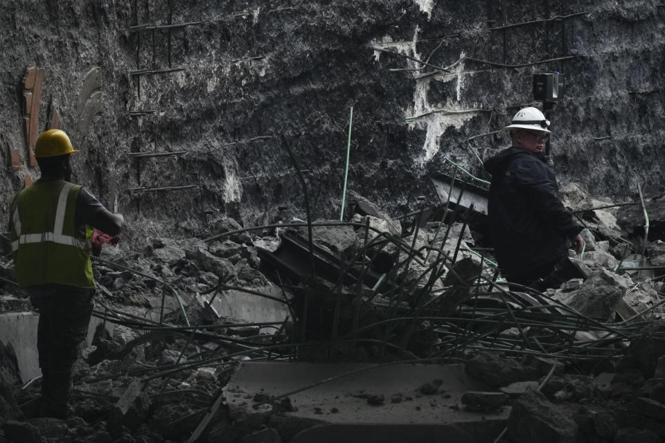 An investigator surveys the aftermath of an elevated section of Interstate 95 that collapsed, in Philadelphia, Monday, June 12, 2023. (AP Photo/Matt Rourke)