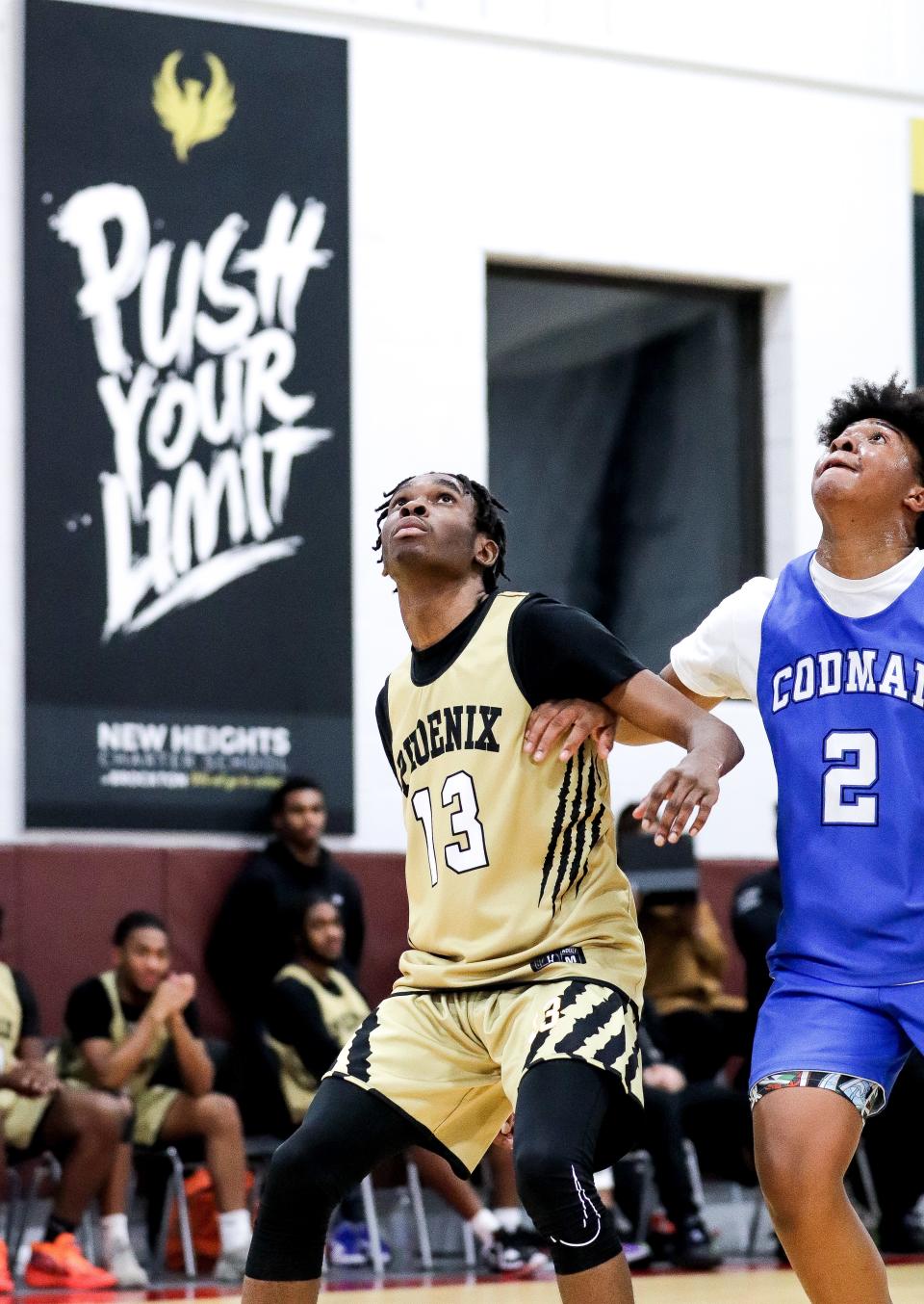 Carlucci Paul of New Heights Charter boxes out with 'Push Your Limit' banner seen in the background during a game against Codman Academy on Monday, Jan. 9, 2023.