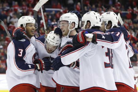 Jan 12, 2019; Washington, DC, USA; Columbus Blue Jackets left wing Artemi Panarin (9) celebrates with teammates after scoring the game-winning goal in overtime against the Washington Capitals at Capital One Arena. The Blue Jackets won 2-1 in overtime. Mandatory Credit: Geoff Burke-USA TODAY Sports