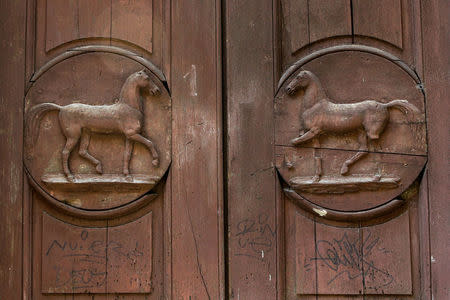 A detail of a door is seen at the Cavallerizza Reale building, which is occupied by the "Assemblea Cavallerizza 14:45" movement in Turin, Italy, July 20, 2016. REUTERS/Marco Bello