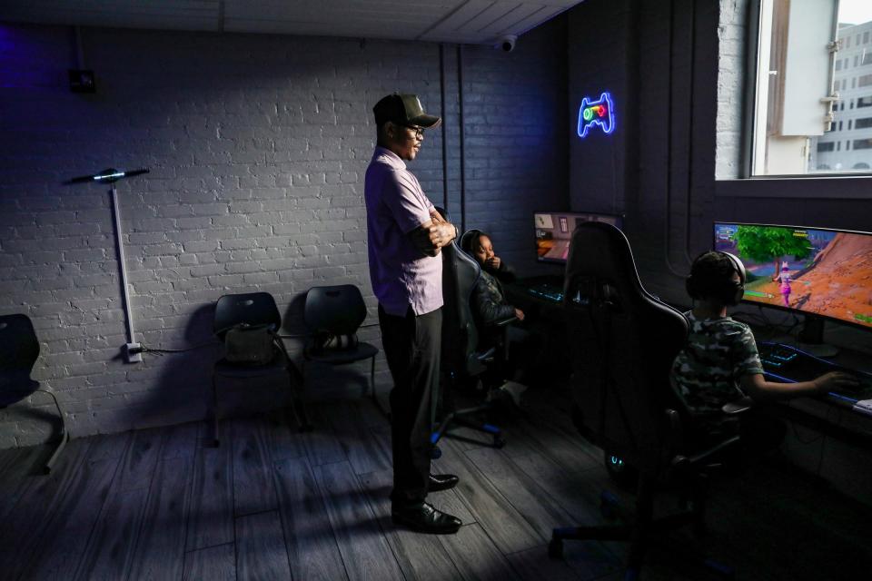 Bert Marks, 30, of Detroit, looks on as students play video games, during the Franklin Wright Settlements after-school enrichment program at its Midtown location on Wednesday, Feb. 28, 2024.