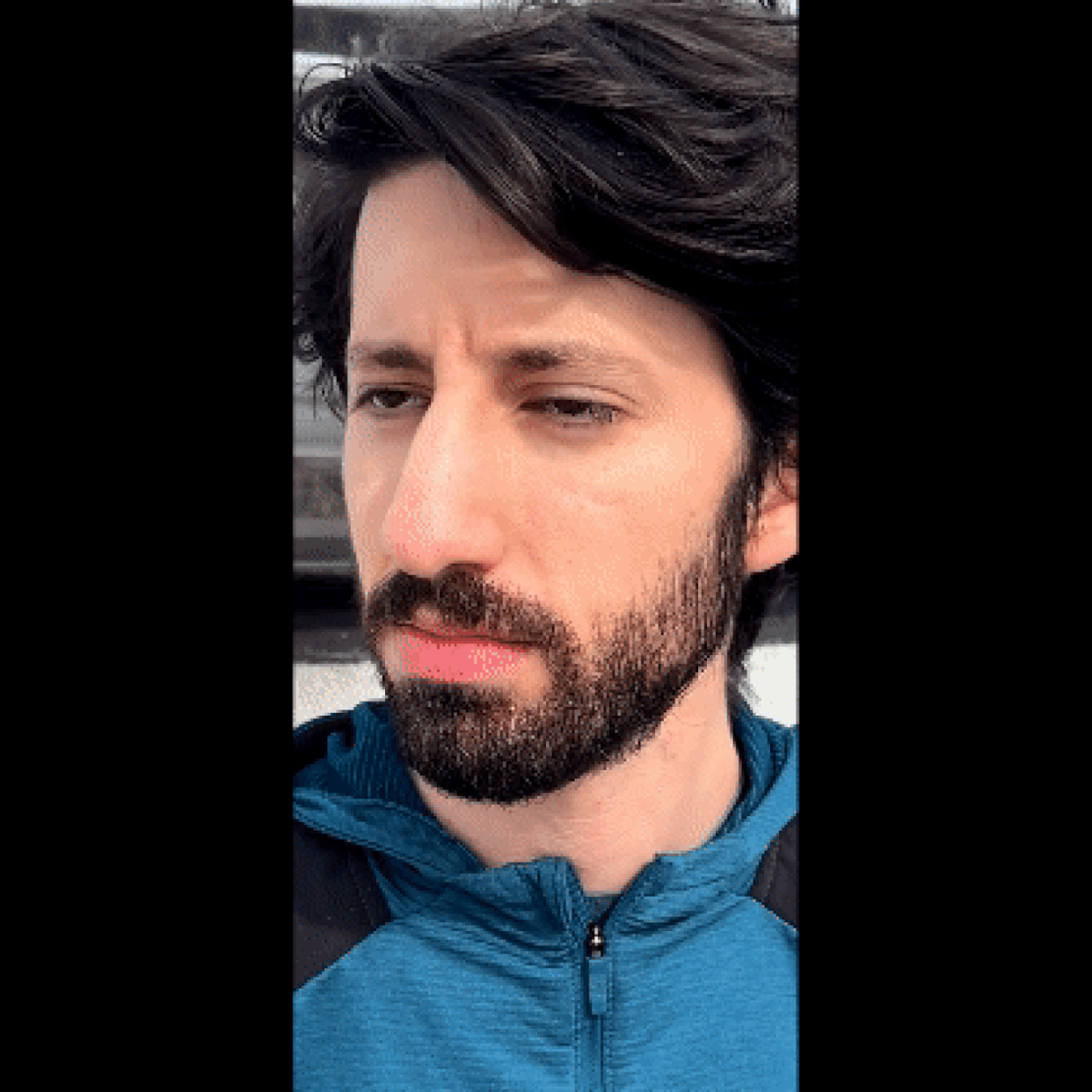 Close-up GIF of the reporter putting the Bose Ultra Open Earbuds in his ears, one at a time. (Courtesy Harry Rabinowitz)