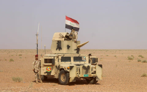 Iraqi pro-government forces advance towards the town of Rawa - Credit: AFP PHOTO / MOADH AL-DULAIMI