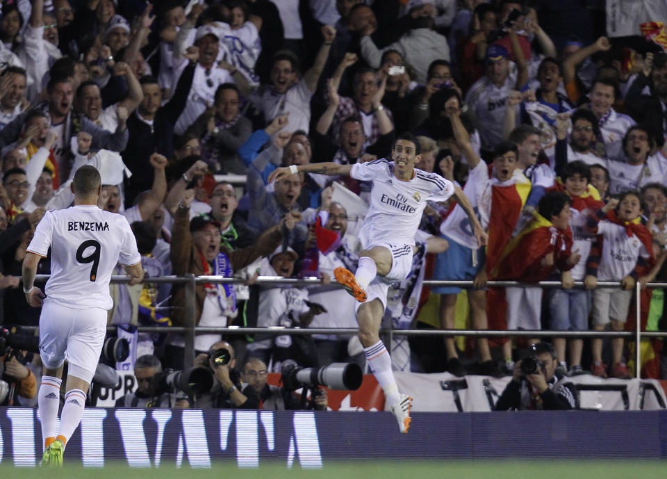 Real's Angel Di Maria, right, celebrates after scoring during the final of the Copa del Rey between FC Barcelona and Real Madrid at the Mestalla stadium in Valencia, Spain, Wednesday, April 16, 2014. (AP Photo/Alberto Saiz)