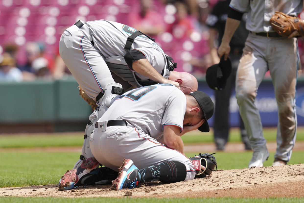 Miami Marlins catcher Jacob Stallings checks on pitcher Daniel Castano\