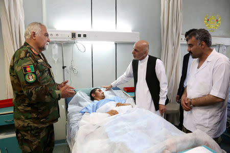 Afghanistan's President Ashraf Ghani visits a victim wounded in April 21's attack on an army headquarters, in Mazar-i-Sharif, northern Afghanistan April 22, 2017. Presidential Palace /Handout via REUTERS