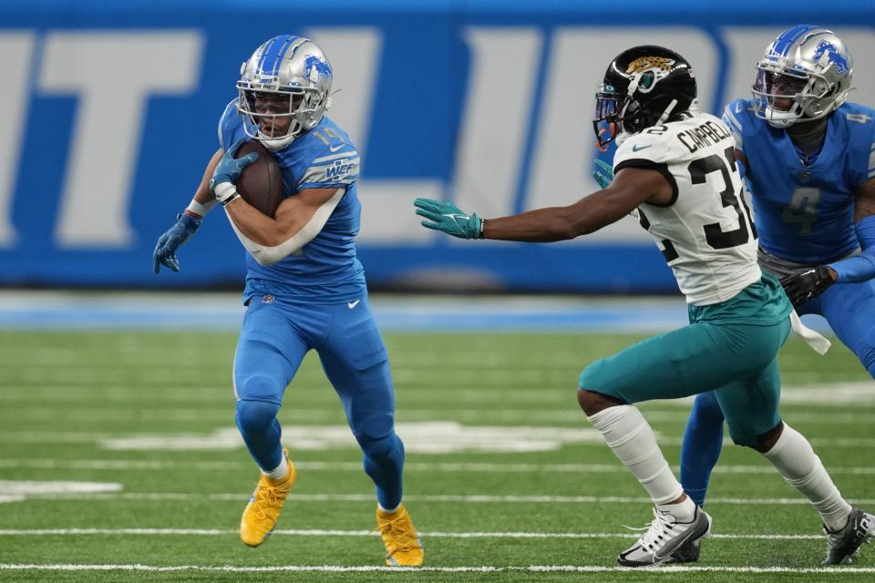 Detroit Lions wide receiver Amon-Ra St. Brown runs by Jacksonville Jaguars cornerback Tyson Campbell (32) during the first half of an NFL football game, Sunday, Dec. 4, 2022, in Detroit. (AP Photo/Paul Sancya)