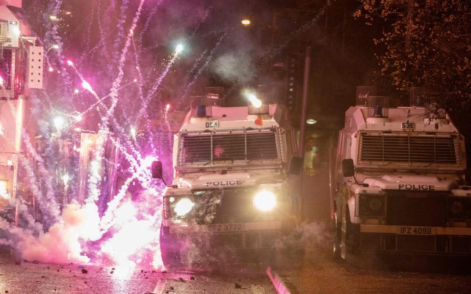Police vehicles were pelted with fireworks on Thursday night - GETTY IMAGES