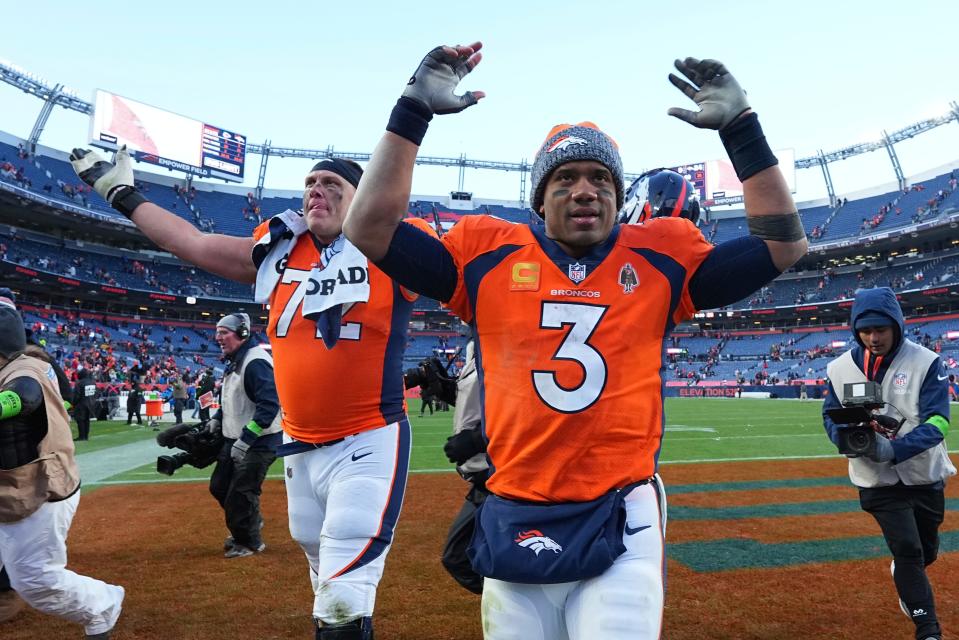 Denver Broncos offensive tackle Garett Bolles (72) and Denver Broncos quarterback Russell Wilson (3) celebrate the win against the Kansas City Chiefs of an NFL football game Sunday October 29, 2023, in Denver.