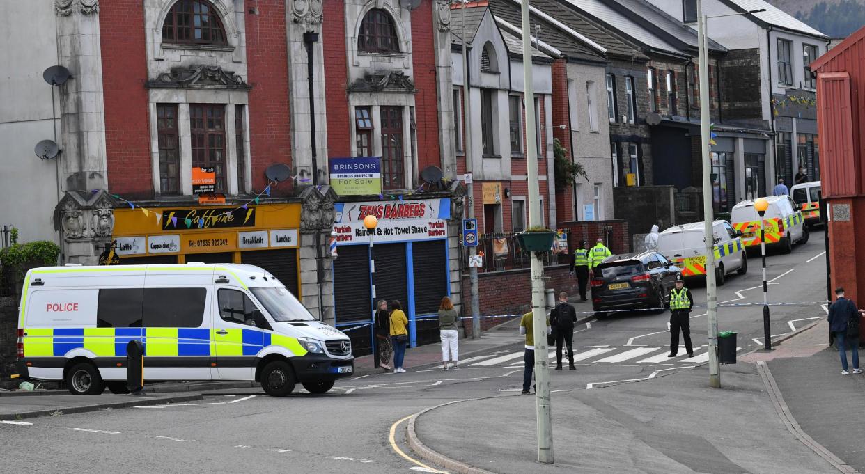 Police officers at the scene after a fatal stabbing in south Wales: PA